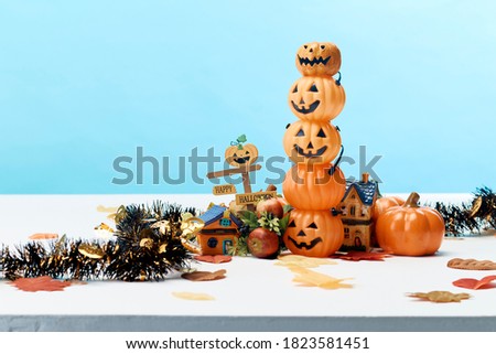 Happy Halloween holiday pumpkin jack o lantern party decorations   on a blue background Copy space for text.