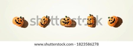 Miniature Halloween pumpkin ghosts - overhead view flat lay