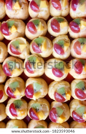 Closeup of " sus buah" or fruits soes with colorful red, green and yellow from kiwi, manggo and greep. Defocused, Blurry background