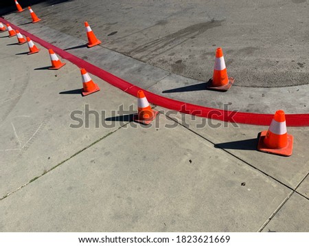 Traffic cones and fresh paint red fire lane curb