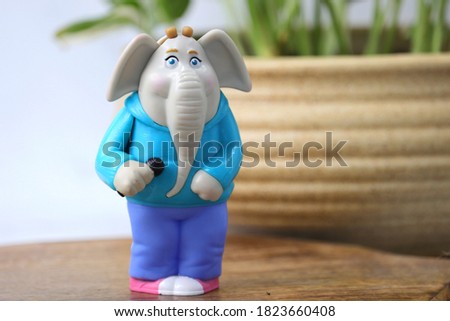 Cute and colorful Plastic elephant toy with green jungle background. Kids banner or poster along with copy space.