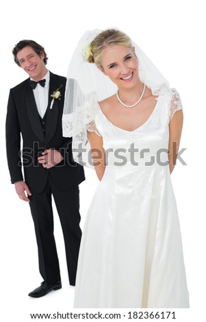 Portrait of beautiful bride standing with groom isolated over white background