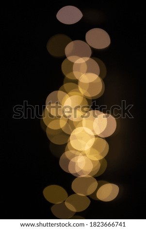 Gold sparkling bokeh on  black background for texture or design. Copy space 