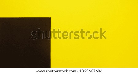  Abstract colored bright paper background. Black square on yellow background, top view. Minimalism                             