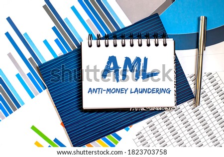 Notebook with Toolls and Notes about AML with charts and pen ,business concept