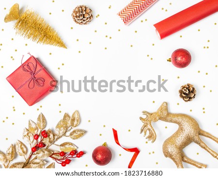 Christmas background - gift box, mistletoe, fircones,reindeer and christmas balls in golden and red colors over white background. 
