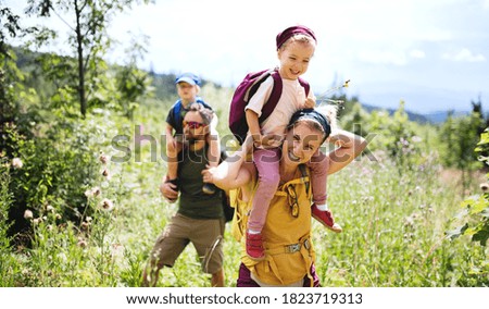 Family with small children hiking outdoors in summer nature. Royalty-Free Stock Photo #1823719313