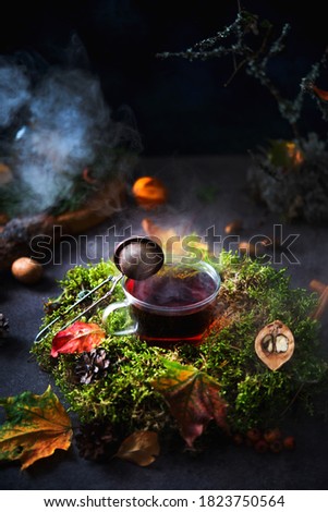 Autumn composition, a Cup of hot tea with steam surrounded by forest scenery, creative picture