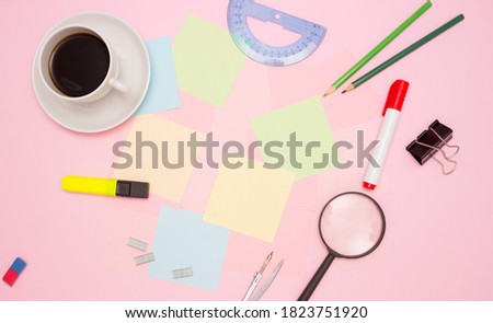 Concept of office, work at the table. Office supplies in the form of a frame, a Cup of coffee, empty note papers in the center. Topview, copyspace.
