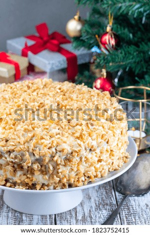 Carrot cake decorated with cream cheese frosting and walnuts, Christmas decoration on a background, vertical