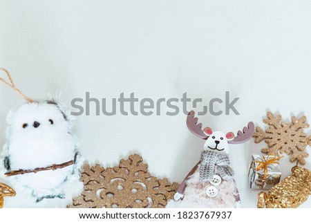 Deer, owl and golden Christmas decorations on a white background. Copy space.