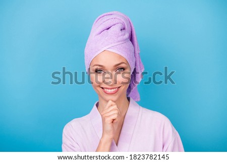 Photo of pretty woman finger chin shiny beaming smile wear purple towel turban bathrobe isolated blue color background