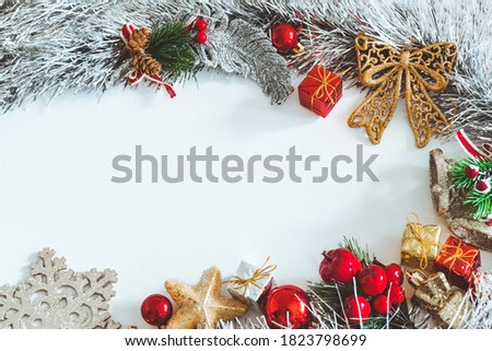 Frame made of red and gold Christmas decorations on a white background. Copy space.