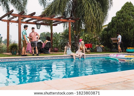 Barbecue at the pool.  Group of friends enjoy a day at the pool.  Concept of summer and friendship.