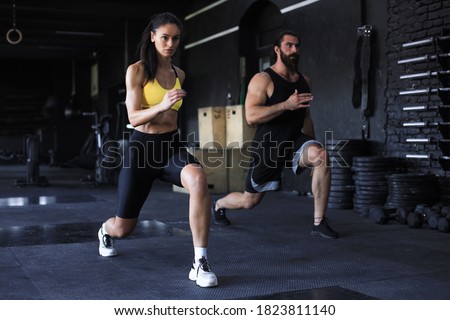 Attractive sport couple doing fitness at gym. Royalty-Free Stock Photo #1823811140
