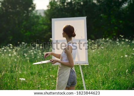 the artist paints a picture outdoors paint palette easel