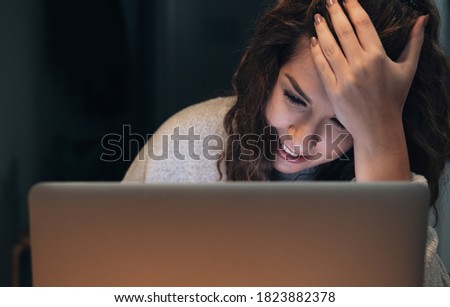 Close up portrait of woman working late on laptop stock photo