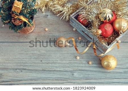 Christmas or New Year composition, wood background background with gold Christmas decorations