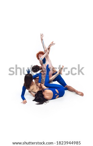 Group of modern dancers, art contemp dance, blue and white combination of emotions. Flexibility and grace in motion and action on white studio background. Fashion and beauty, artwork concept.