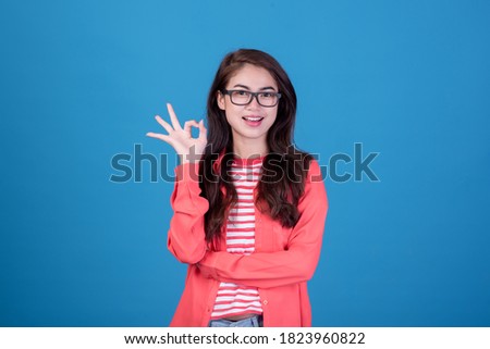 Portrait of beautiful asia young woman on Blue color background with copy space. Human face expressions, emotions feelings, body language,beauty and fashion concept.