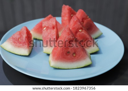 Slices of a watermelon on a blue plate