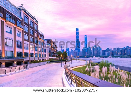 City skyline at dusk,Pudong's Lujiazui Financial and Trade Zone,Shanghai,China. Viewed from a footpath by the Huangpu river.