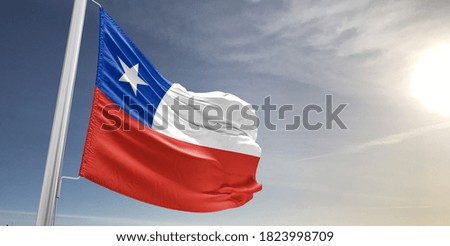 Chile national flag cloth fabric waving on beautiful sky.