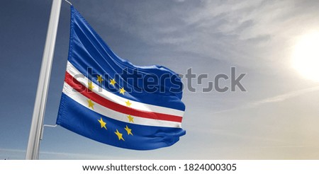 Cabo Verde national flag cloth fabric waving on beautiful sky.