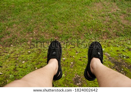 A man with black shoes in the forest 