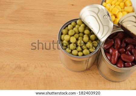 Canned food on wooden background