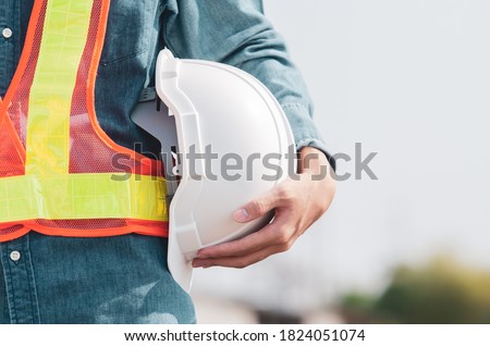 White safety helmet is in the hands of an engineer. Royalty-Free Stock Photo #1824051074