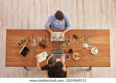 Man and women colleague at the office and same table, working and up style.