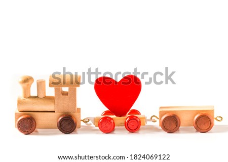 red heart shape with wooden toy train isolated on white background.