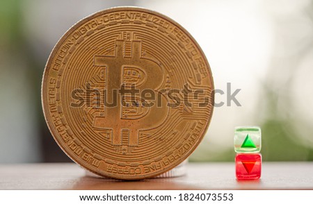 Bitcoin coin, near have green symbol in it has a triangle point in up and red symbol in it has a triangle pointing downwards, Concept  Price fluctuation of the Bitcoin or cryptocurrency.