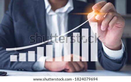 Businessman pressing graph on visual screen in concept of suscess business.