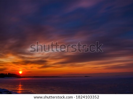 Pictures of a sunset on the frozen Baltic Sea near the Finnish town of Rauma in winter