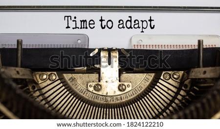 Text 'time to adapt' typed on retro typewriter. Business concept.