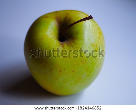 isolated green apple on a white table