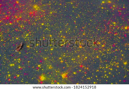 abstract bright background of paint splashes on asphalt