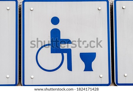 A closeup shot of the sign of a bathroom for disabled people