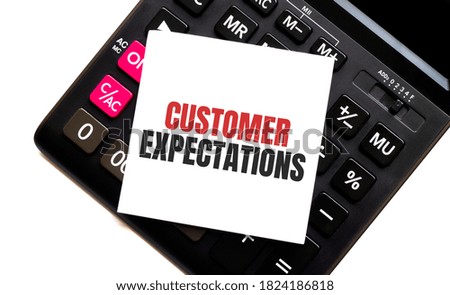 calculator with text CUSTOMER EXPECTATIONS with white paper