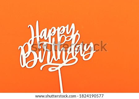 happy birthday wooden text concept isolated on orange background