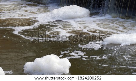 Foaming unclean water, concept of pollution and water contamination Royalty-Free Stock Photo #1824200252