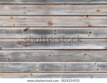 Old dark gray wall made of pine wood planks. Front view, background photo texture