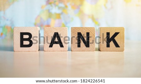 The word bank written on wooden cubes isolated on a political map background