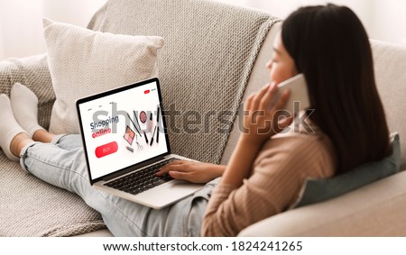Female Shopping Concept. Back view of woman browsing online make up store, talking on phone, sitting at home Royalty-Free Stock Photo #1824241265
