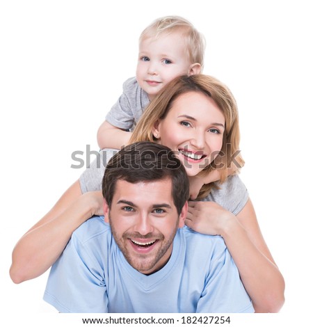Portrait of happy young family with children lying on the floor - isolated on white background.