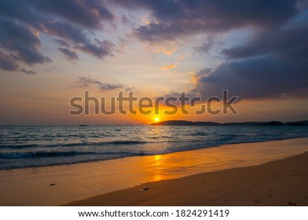 Sunset over the tropical sea and beautiful dramatic clouds.