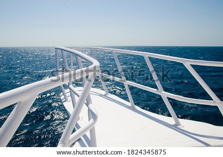 view of the blue sea water from the yacht. summer vacation on a boat. white the railing of the ship. the water from the boat