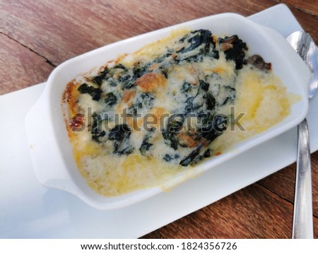 Closed up Baked spinach with cheese,Baked spinach with cheese, studio shot,spinach cheese bake.